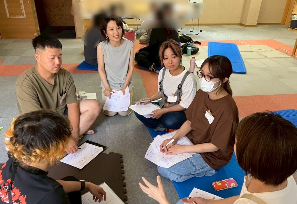 児童発達支援・放課後等デイサービス・学童保育の職員研修の様子。株式会社BUZZBUZZと株式会社ウッドフィールの職員が、自己理解から始まる他者理解をテーマに対話を通して学んでいる場面。